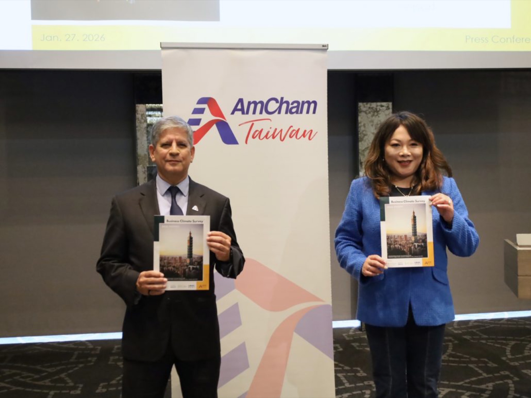 Two speakers presenting the Business Climate Survey at an AmCham press conference